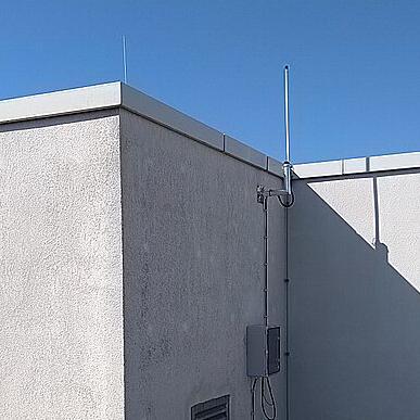 LoRAWAN-Antenne ist auf dem Dach eines Gebäudes befestigt.