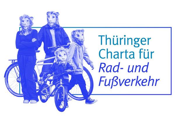 Mehrere Personen verschiedenen Alters mit Löwenmasken und Fahrrädern